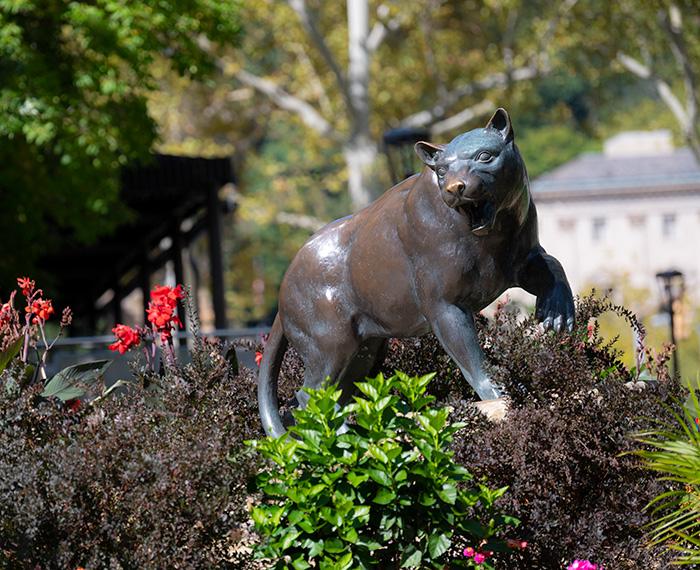 A panther statue surrounded by plants