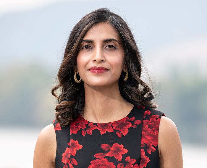 Gurkar in a black dress with red flowers