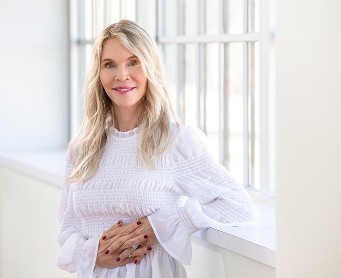 Nelson in a white blouse