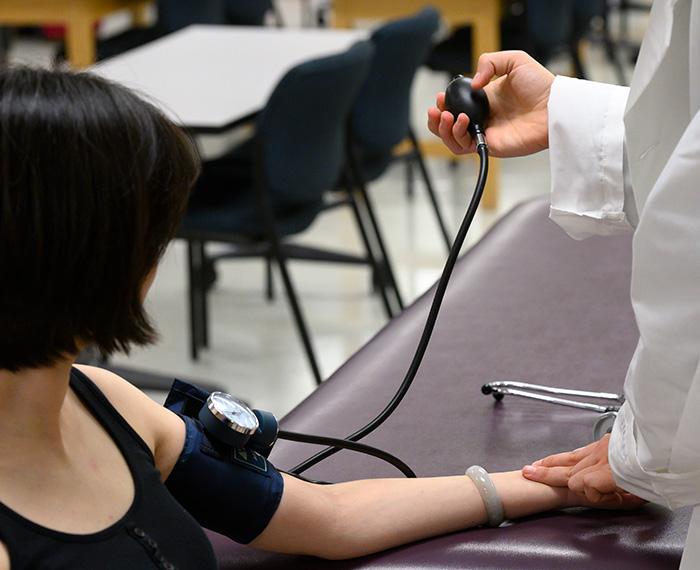 A doctor takes a patient's blood pressure