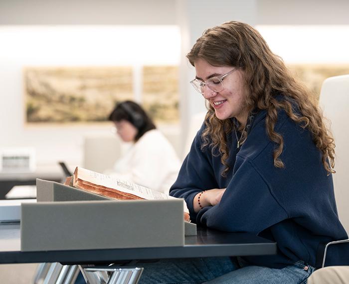 A person reads from an old book