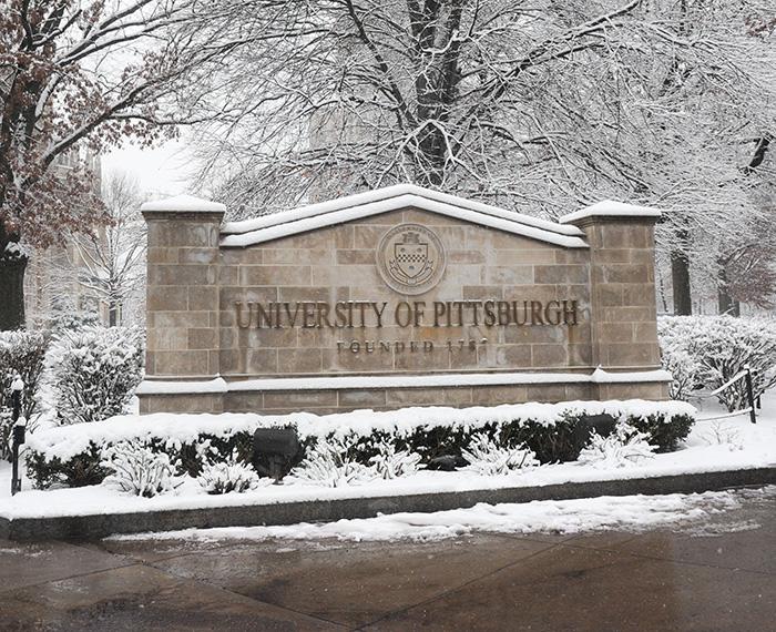 The University of Pittsburgh sign on a snowy day