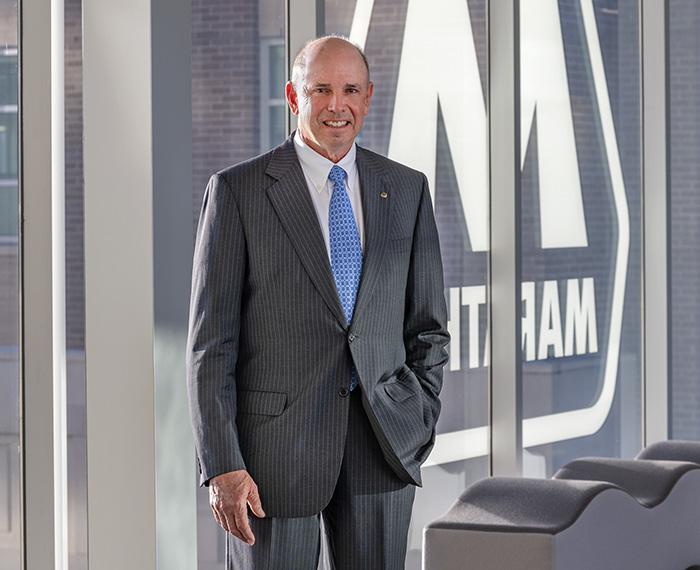 John Surma in a gray suit