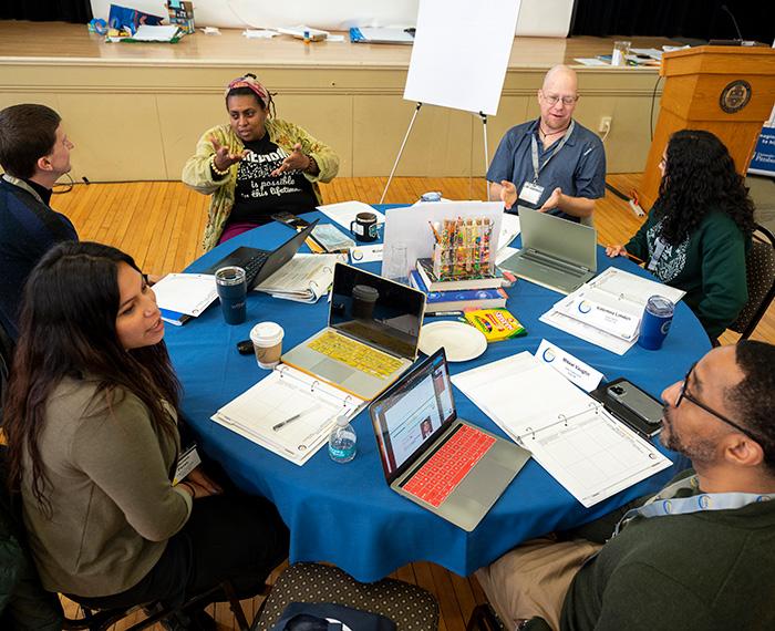 A discussion group sits around a table