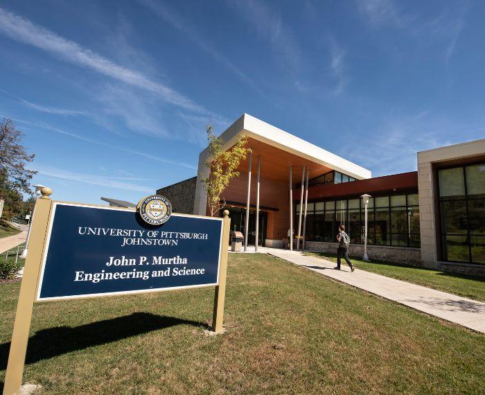 A person walks into the Pitt-Johnstown John P. Murtha Engineering and Science Building.