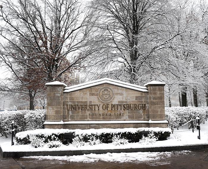 The University of Pittsburgh sign on a snowy day