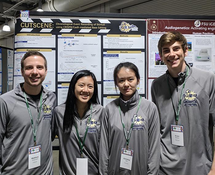 Researchers in front of their study poster