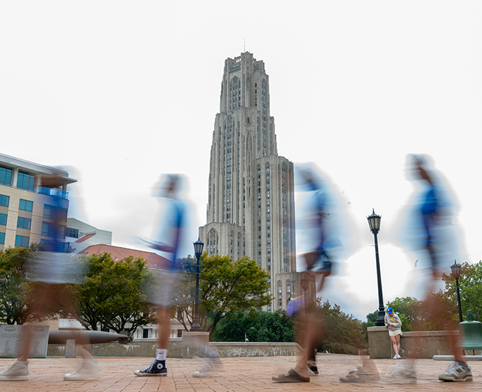 Cathedral of Learning, with blurry students in foreground