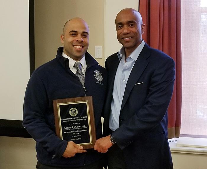 Dickerson holds his award with Dean James Martin