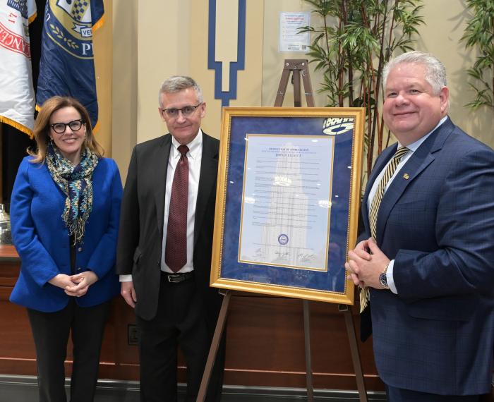 Chancellor Joan Gabel and Board of Trustees Chairperson John J. Verbanac pose with the retiring Director of Internal Audit John P. Elliott during a meeting with a special resolution for Elliott held in the William Pitt Union.