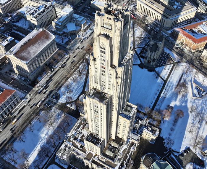 An aerial view of the Cathedral of Learning during the winter.