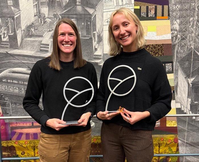 Sleva and Klug hold up their trophies