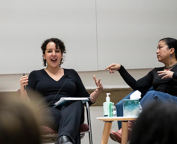 A fellow panelist points to Angie Cruz