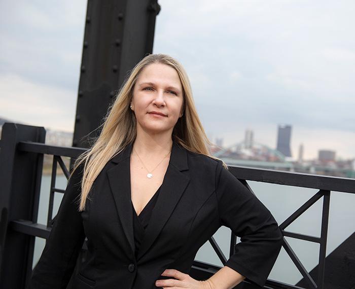 Melissa Bilec on a bridge with Pittsburgh in the distance