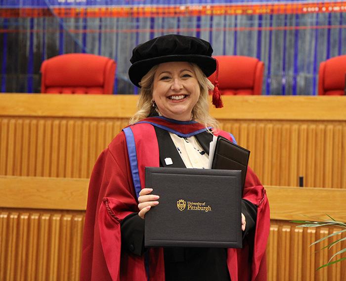 Dean Nicola Foote holds accolade