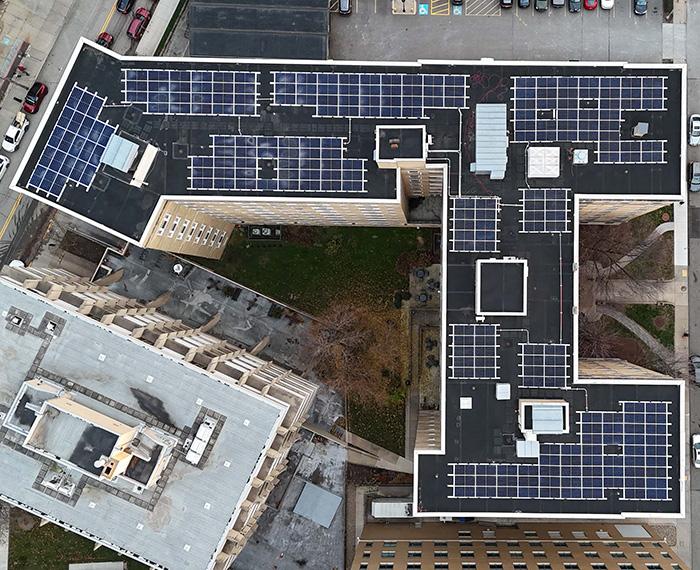 Many solar panels on a rooftop