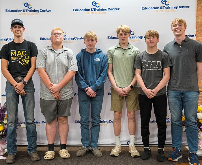 Titusville students standing in front of a screen reading Education & Training Center