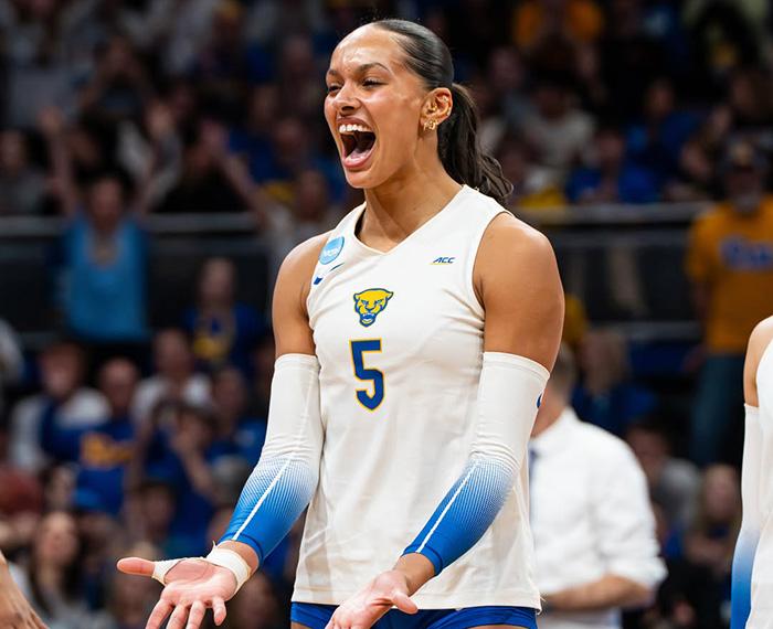 Olivia Babcock celebrates on the volleyball field