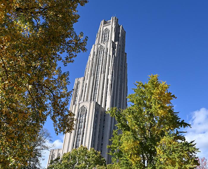 Cathedral of Learning with trees surronding turning leaves for the fall