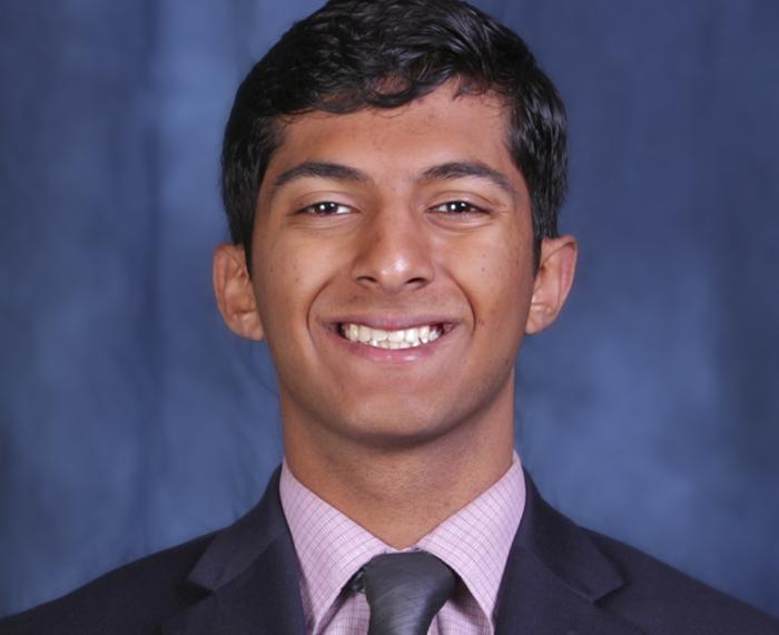 Kannarkat smiling in front of a blue background