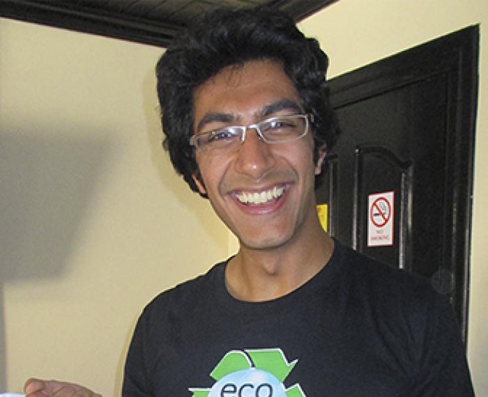 Samir holding a bucket of soap
