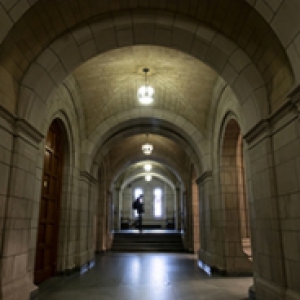 Hallway of the Cathedral of Learning, with a student walking in the background