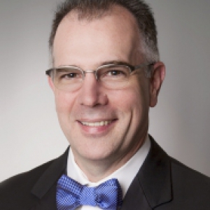 Costello in a blue bowtie and black jacket