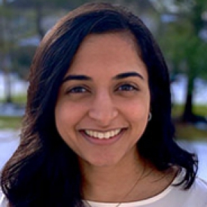 Aarti Patel in a white shirt in front of a snowy field