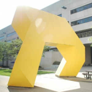 yellow statue in front of a building