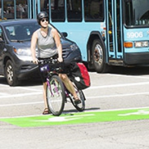 woman on a bike waiting in a green box