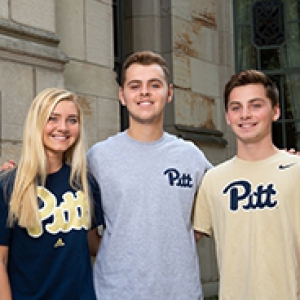 the triplets together in Pitt shirts before the Cathedral