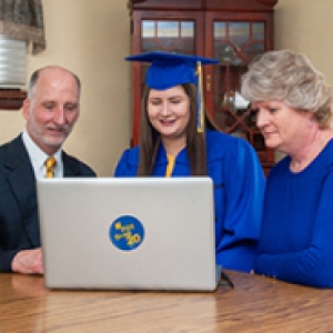 A family watches commencement online 
