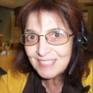 Haberman in a headset and yellow sweater