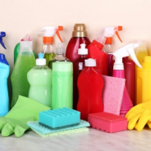 An array of cleaning supplies in rainbow order