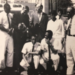 A black and white photo of a group of people posing for a photo together