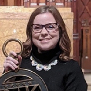 Molly Brandenburg holding a large metal decorative piece