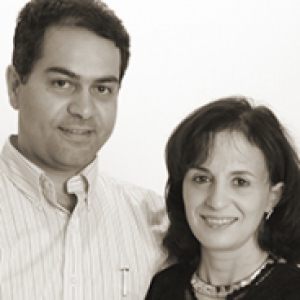 a man and woman standing together smiling