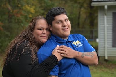 Mother posing with adult son