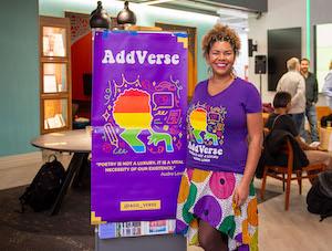 Woman poses next to a sign reading "AddVerse"