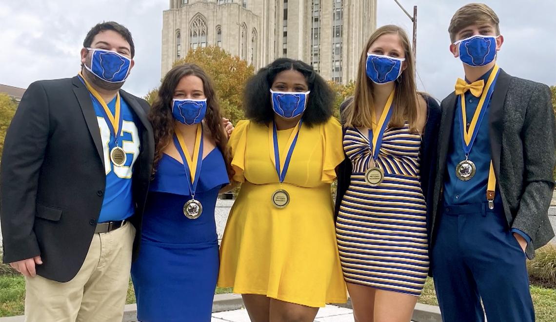 Pitt students in blue and gold linking arms