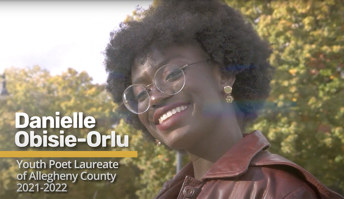 Danielle Obisie-Orlu smiling outside with glasses and maroon jacket