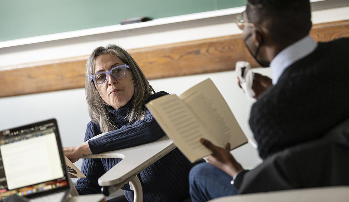 Ellen Smith speaking with student in class