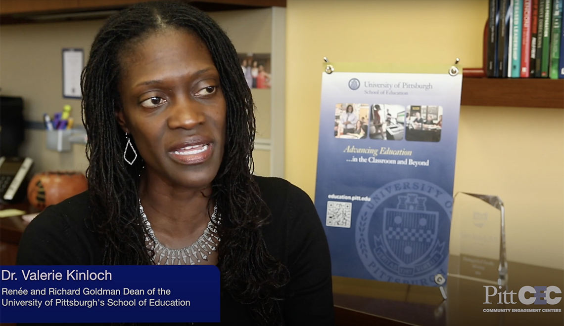 Valerie Kinloch sitting next to desk and talking during interview