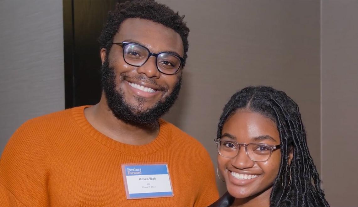 Two people smile