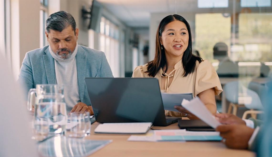A person speaks to a team during a meeting