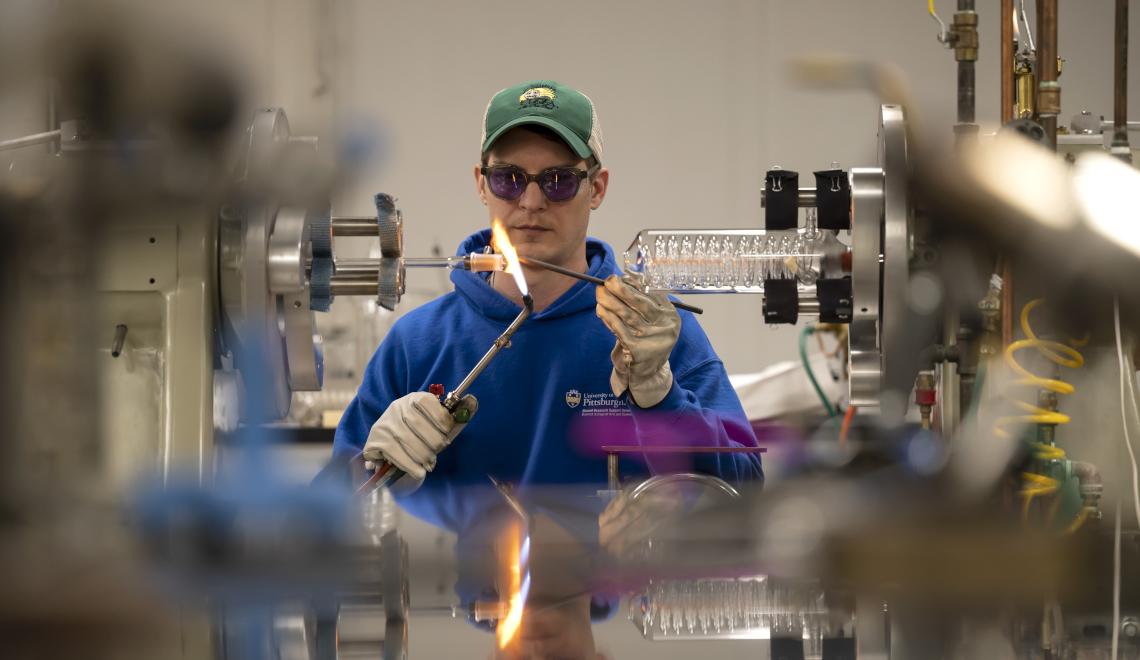 Ryan Tate heats up a piece of glass with a blowtorch