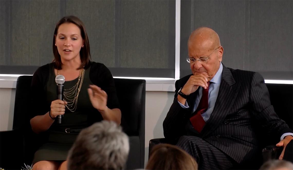 Two people sit on a panel