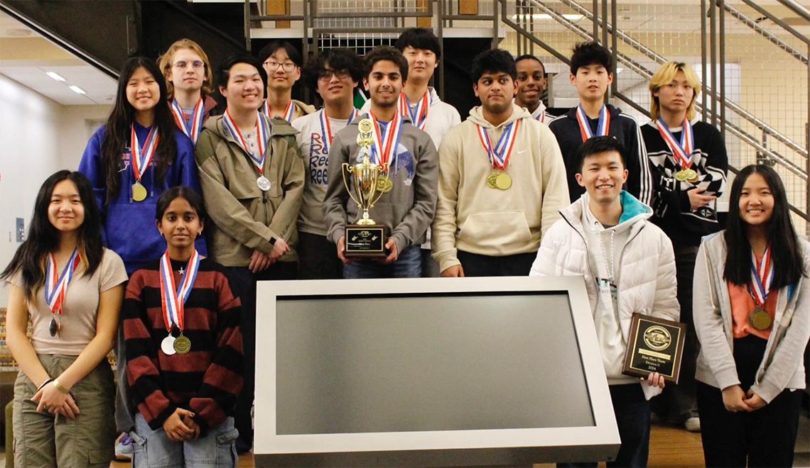 The Science Olympiad team with medals and trophies
