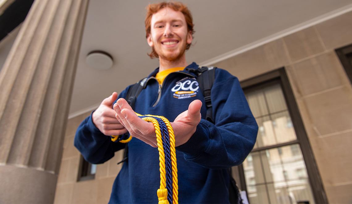 A student holds their cords during Graduation Central in the Schenley Quad.